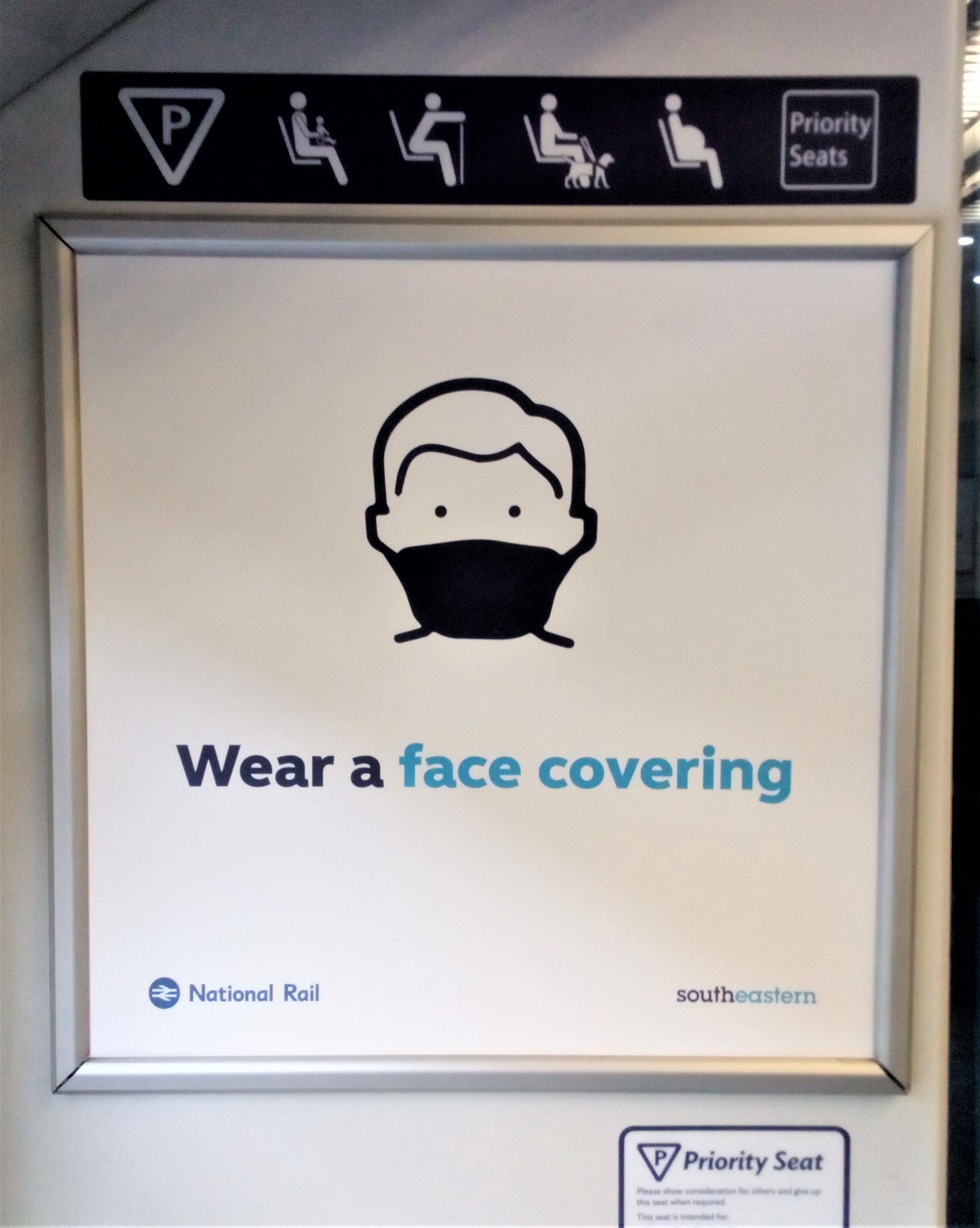train sign saying wear a face covering